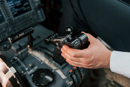 Close up view. Pilot on the work in the passenger airplane. Preparing for takeoffの写真素材