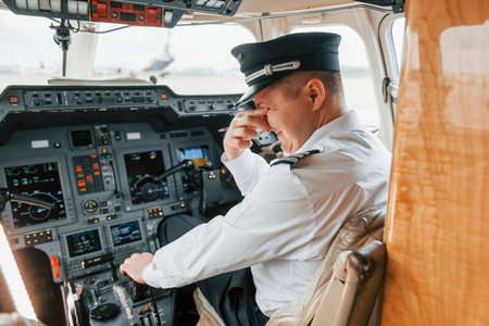 Pilot on the work in the passenger airplane. Preparing for takeoffの写真素材