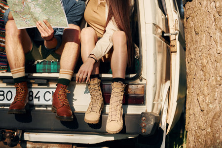 Weekend activities. Young couple is traveling in the forest at daytime togetherの写真素材