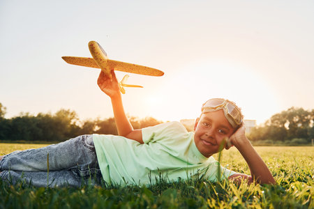 African american kid have fun in the field at summer daytimeの写真素材