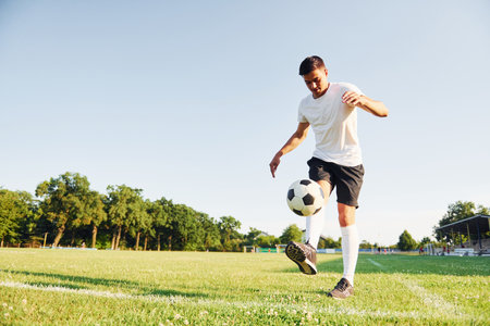 Summer daytime. Young soccer player have training on the sportive fieldの写真素材