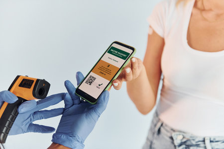 Receiving passport. Doctor in uniform making vaccination to the patientの写真素材