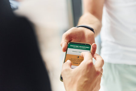 Doctor in uniform making vaccination to the patientの写真素材