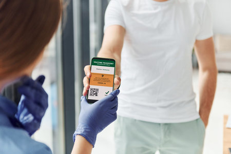 Doctor in uniform making vaccination to the patientの写真素材