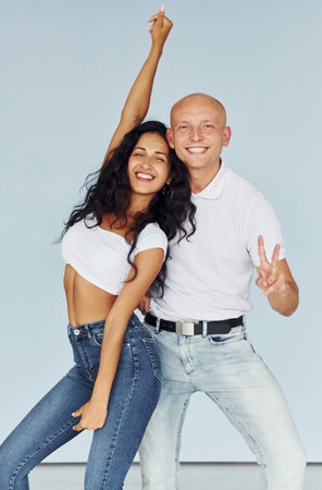 Gesturing and having fun. Cheerful couple is together indoorsの写真素材