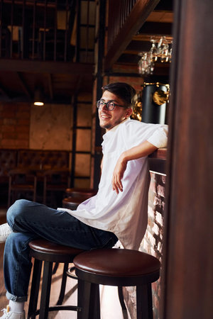 One person. Man in casual clothes sitting in the pubの写真素材