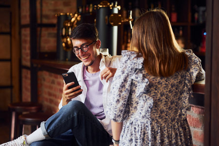 People in casual clothes sitting in the pubの写真素材