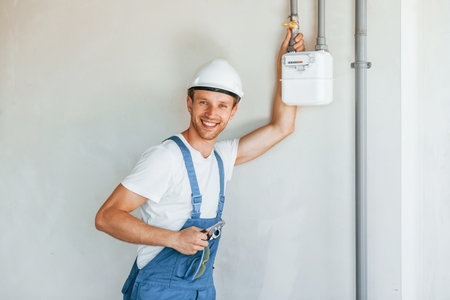 Modern technologies. Young man working in uniform at construction at daytimeの写真素材