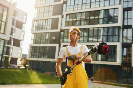 Man cut the grass with lawn mover outdoors in the yard