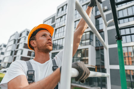 Big project. Young man working in uniform at construction at daytimeの写真素材