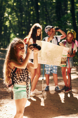 With touristic equipment. Kids strolling in the forestの写真素材