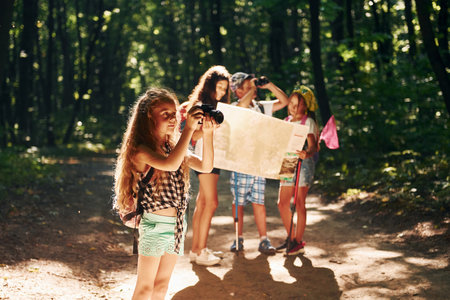 With touristic equipment. Kids strolling in the forestの写真素材