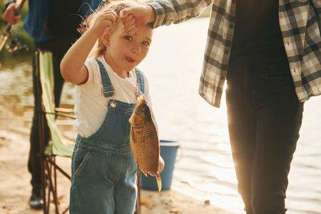 Father with son and daughter on fishing together outdoors at summertimeの写真素材