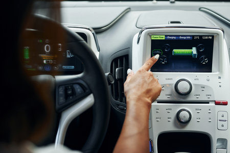 Close up view of front control panel. Woman in casual clothes is sitting in her automobile at daytimeの写真素材