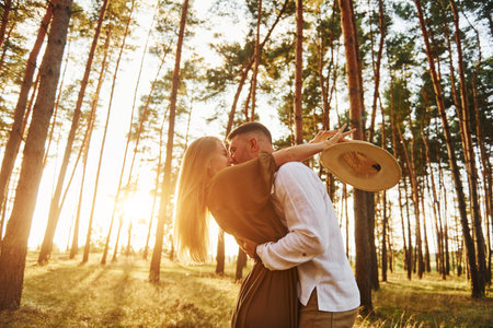 Feeling passion. Happy couple is outdoors in the forest at daytimeの写真素材