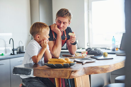 Conception of culinary. Father and son is indoors at home togetherの写真素材