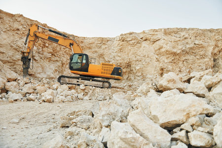 Loading vehicle is outdoors on the borrow pit at daytime