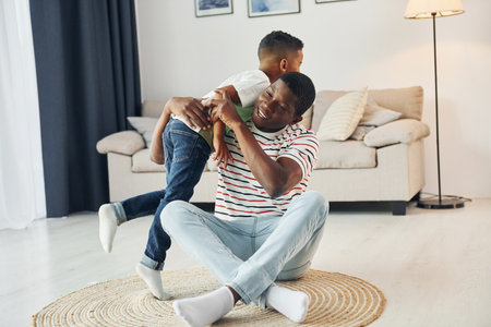 Happy family. African american father with his young son at home.の写真素材