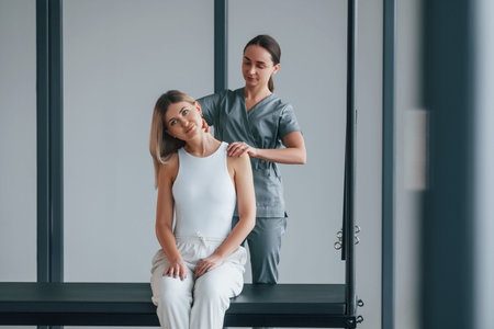Neck exercises. Woman is in health center getting help by doctor.の写真素材
