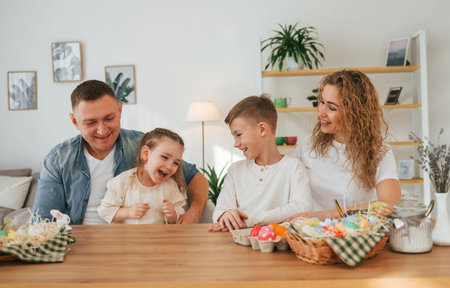 On the kitchen. Happy family celebrating Easter holidays together.