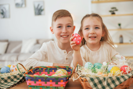 Having fun. Happy little sister and brother celebrating Easter holidays together.