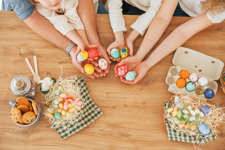 Top view of hands on the table. Happy family celebrating Easter holidays together.