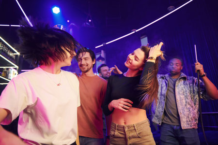 Having a party. Group of friends in the night club together.