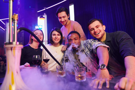Smiling and partying. Group of friends having fun in the night club together.