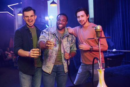 In casual clothes. Group of friends having fun in the night club together.