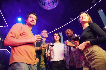 Having a party. Group of friends in the night club together.