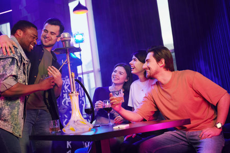 Weekend relax. Group of friends having fun in the night club together.