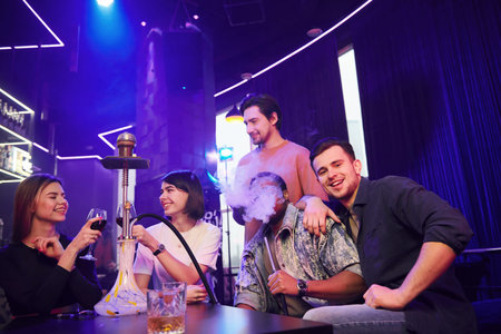 Smiling and partying. Group of friends having fun in the night club together.
