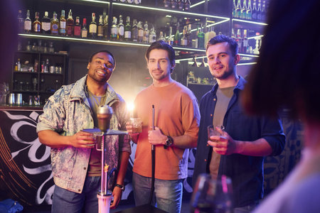 In casual clothes. Group of friends having fun in the night club together.