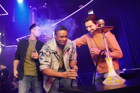 Three friends having fun in the night club together.