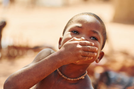 Namibia, Africa - June 14, 2021: Child of the ethnic people of Africa is outdoors. Front view.