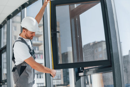 Focused on the work. Repairman is indoors in the modern room.の写真素材