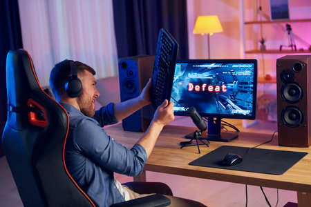 Losing the game. Online streamer playing FPS shooter game at home.