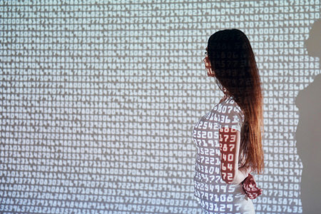 Many of the different numbers. Beautiful young woman is in projector neon lights in the studio.