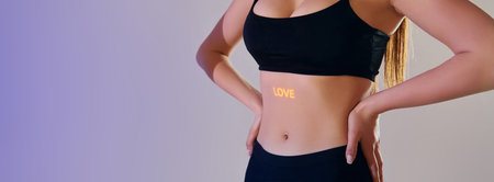 Love word is on the body. Beautiful young woman is in projector neon lights in the studio.