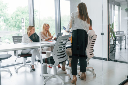 Talking and working on the project together. Group of professional business people is in the office.