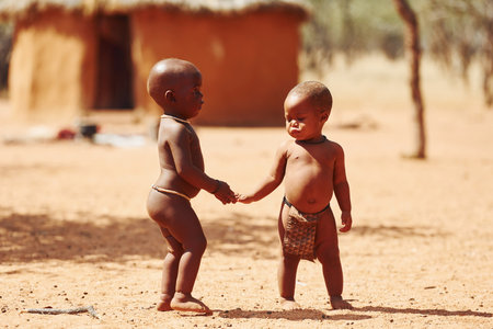 Namibia, Africa - June 14, 2021: Children of the ethnic people of Africa is outdoors. Playing together.のeditorial素材