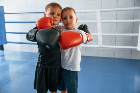 On the ring. Boys training boxing in the gym together.