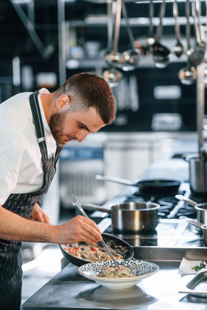 Busy at work. Chef is on the kitchen preparing food.