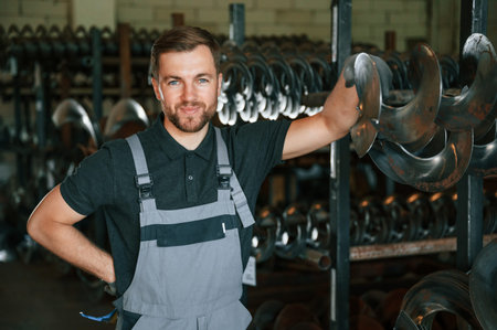 Portrait of man in uniform that is in workstation developing details of agriculture technique.