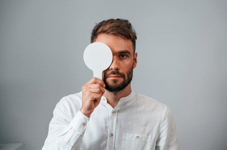 Test of sight. Man is checking his vision indoors in the clinic.