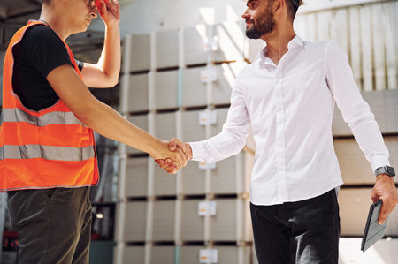 Standing together. Two storage workers is in the warehouse.の写真素材