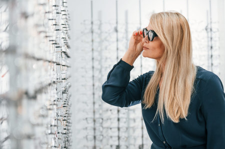 Woman in store trying new glasses.