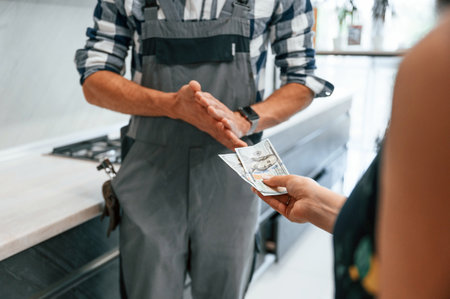 Payment for the work. Close up view. Plumber receiving cash.の写真素材