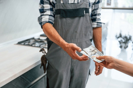 Payment for the work. Close up view. Plumber receiving cash.の写真素材