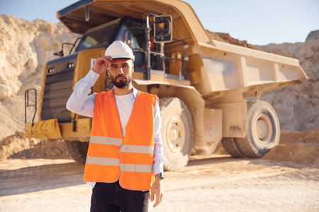 Man in uniform is working in the quarry at daytime.